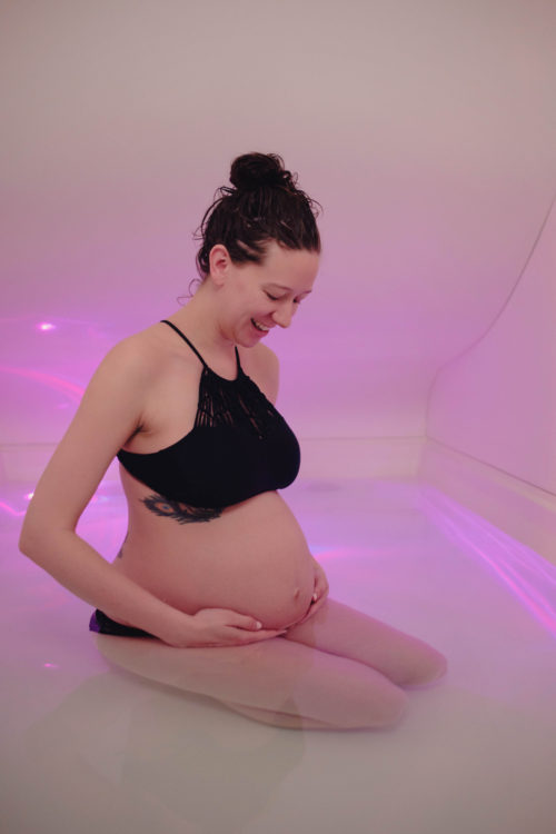 Pregnant woman in float room at Unwind at Westclox